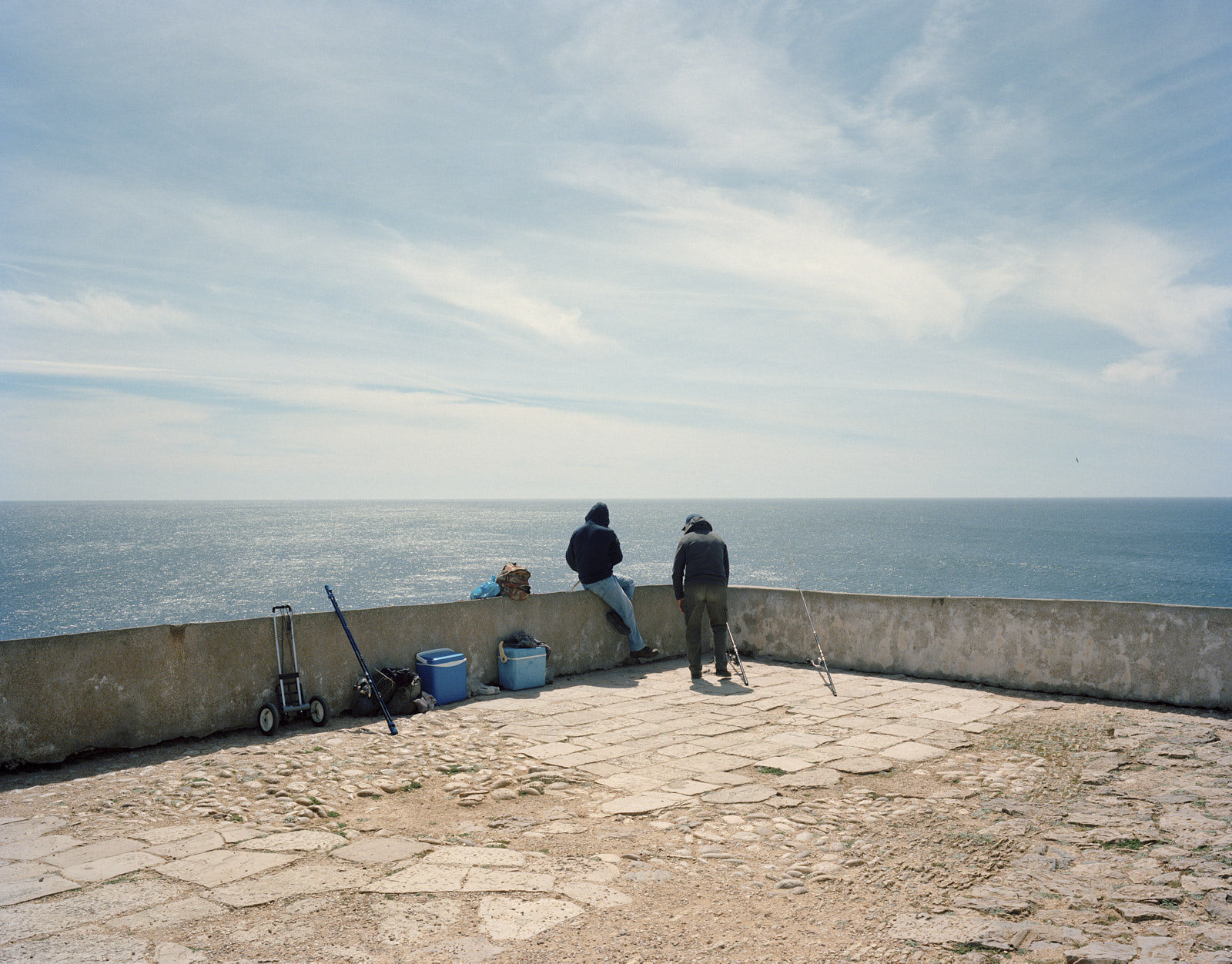 Zwei Fischer in Sagres, gelegen an der südwestlichen Spitze Portugals, das im 15. Jahrhundert die Basis von Prinz Heinrich dem Seefahrer (Infante D. Henrique) war und als logistisches Zentrum des frühen portugiesischen maritimen Kolonialismus diente. Sagres, Portugal ©2023 Jessica Dreier